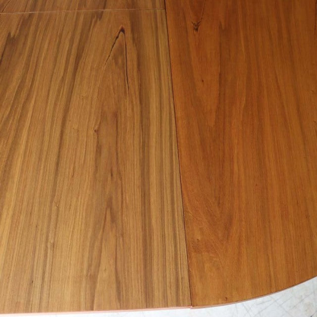 Vintage British Alfred Cox teak round dining table top with rich wood grain and warm mid-century finish.