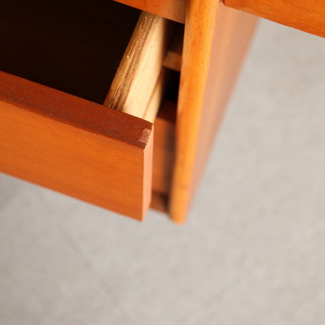 Close-up of vintage British mid-century Austinsuite dresser drawer in warm teak with smooth wood grain and clean lines.