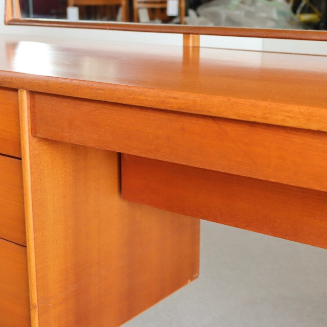 Mid-century British vintage teak dresser by Austinsuite with smooth wood grain and slender legs.