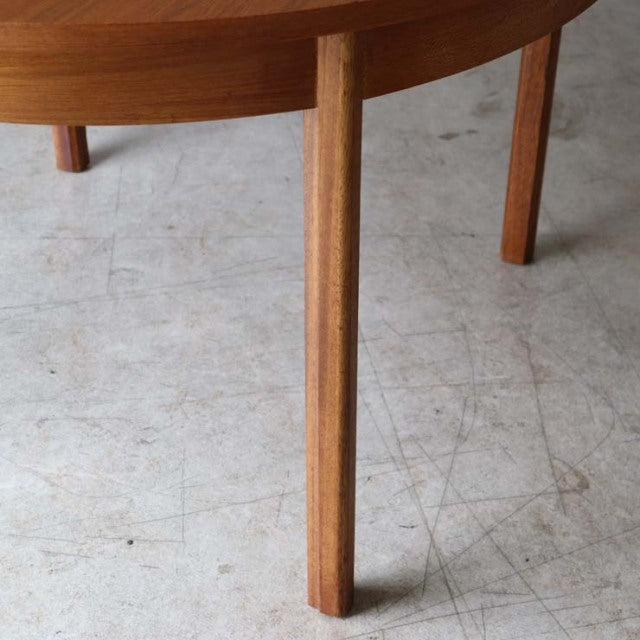 Mid-century British Alfred Cox vintage round teak dining table leg with visible wood grain and smooth finish.