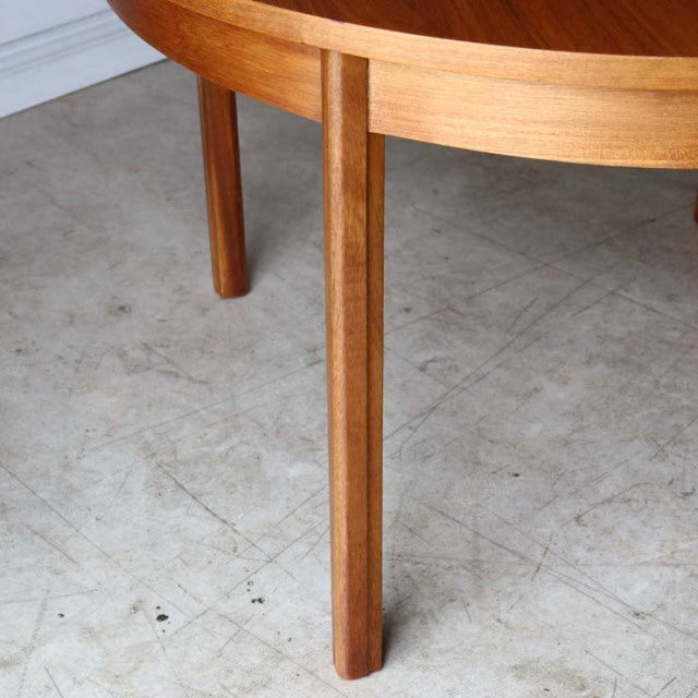 Mid-century British Alfred Cox round teak dining table leg with smooth wood grain and tapered design.
