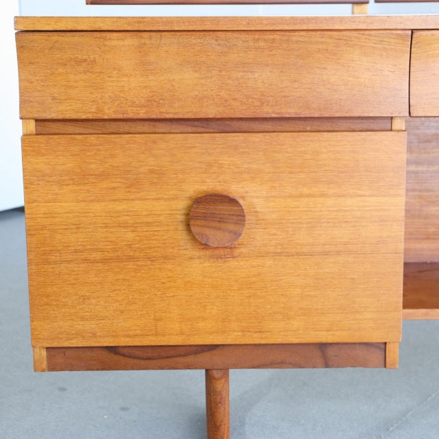 Vintage mid-century teak dresser drawer with smooth wood grain and round recessed handle, British-Danish design.