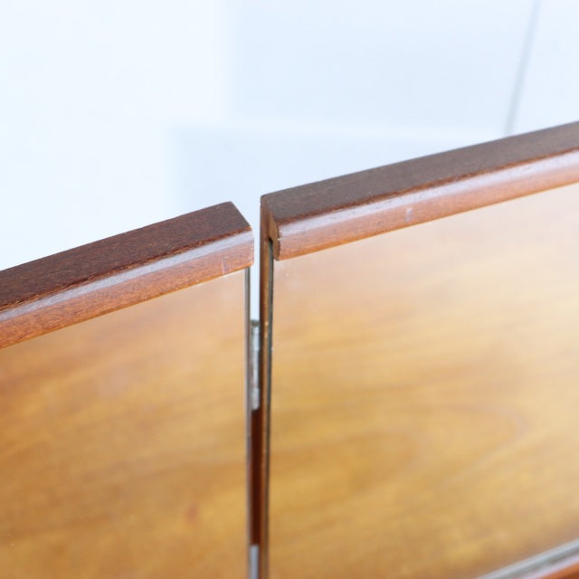 Close-up of mid-century teak wood dresser doors showcasing smooth grain, clean edges, and British-Denmark vintage.