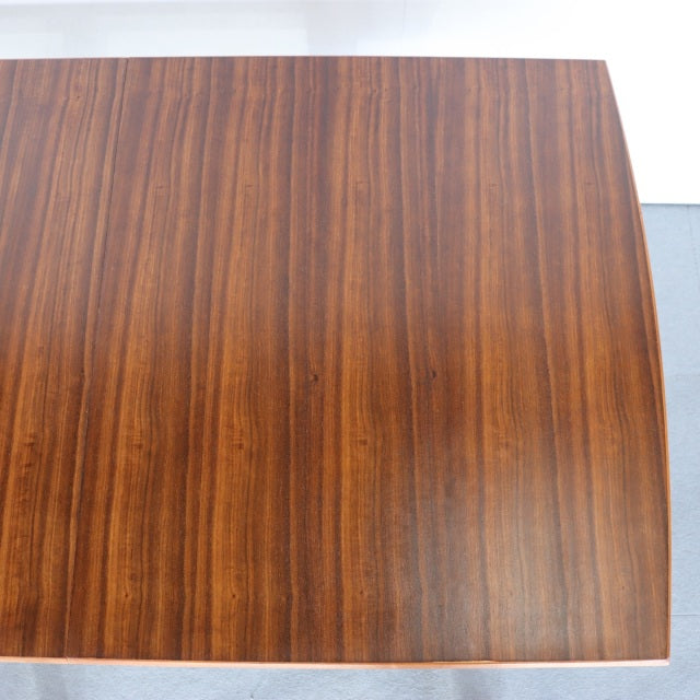 Vintage mid-century teak dining table with rectangular top, smooth wood grain, and simple tapered legs, British-Danish.
