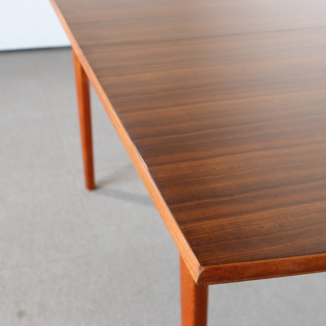 Vintage mid-century teak dining table with finely grained wood surface and tapered square legs, British and Danish design.