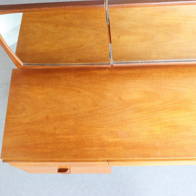 Vintage mid-century teak dresser top with smooth wood grain and split fold-down mirror panels, British-Denmark design.