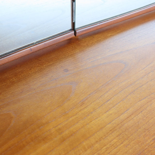 Vintage teak dresser surface with smooth wood grain and mid-century British-Denmark design details.