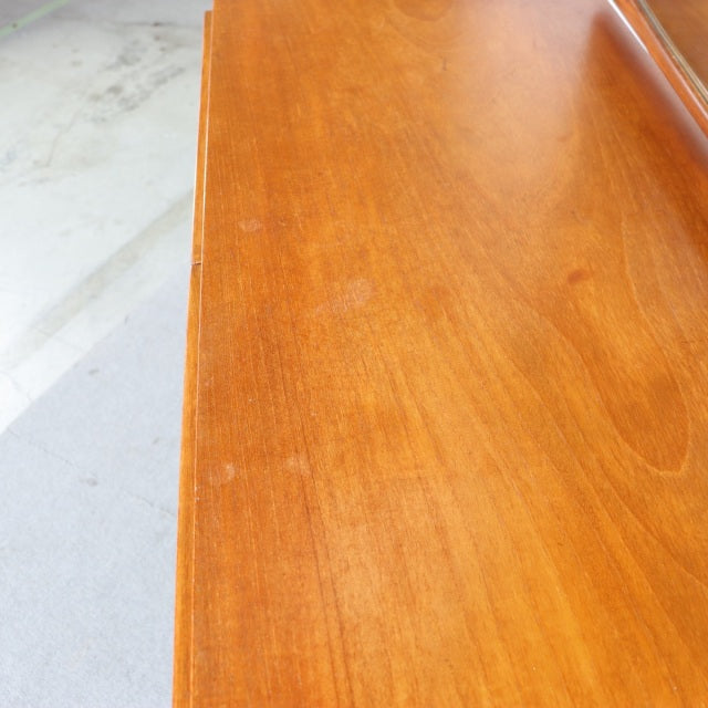 Mid-century vintage teak dresser surface with smooth wood grain and warm golden-brown finish, British and Danish design.