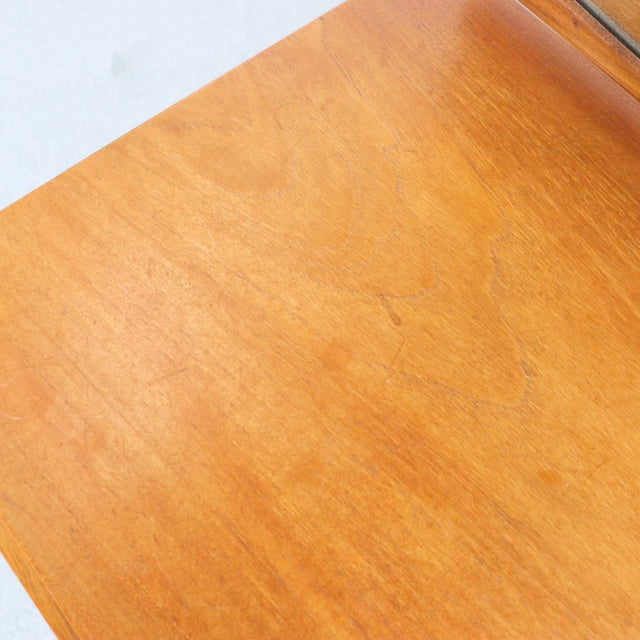 Close-up of vintage mid-century teak wood surface showing smooth grain and warm golden-brown tones on British-Denmark.