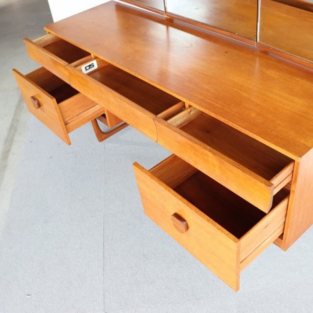 Vintage teak British mid-century dresser with clean wood grain, three drawers, and minimalist legs from Denmark.