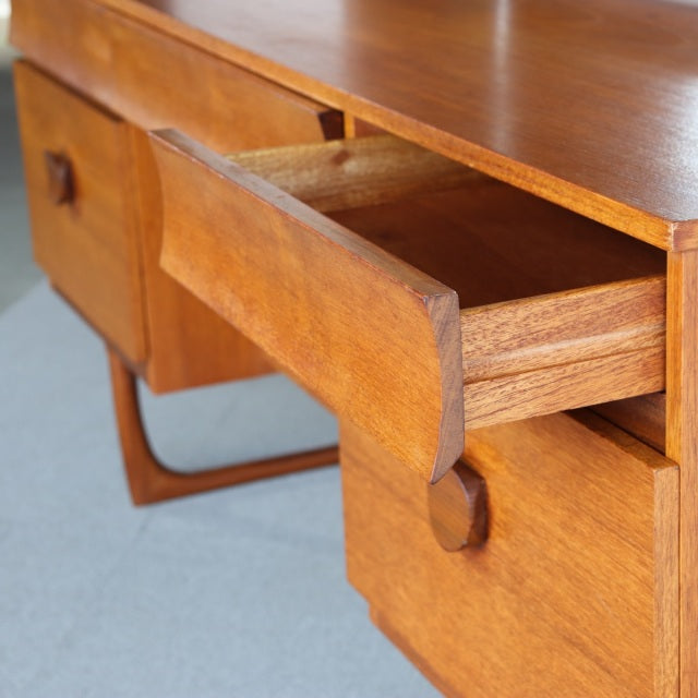 Mid-century British teak dresser from Durable Suites with smooth wood grain and rounded drawer handles, vintage Danish.