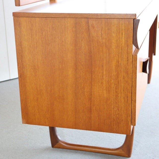 Vintage teak mid-century British dresser from Durable Suites with smooth wood grain and sculpted legs.