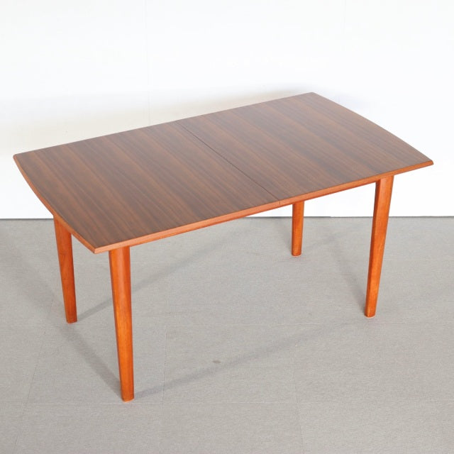 Vintage mid-century British teak dining table with rectangular top, rich wood grain, and tapered legs from Denmark style.