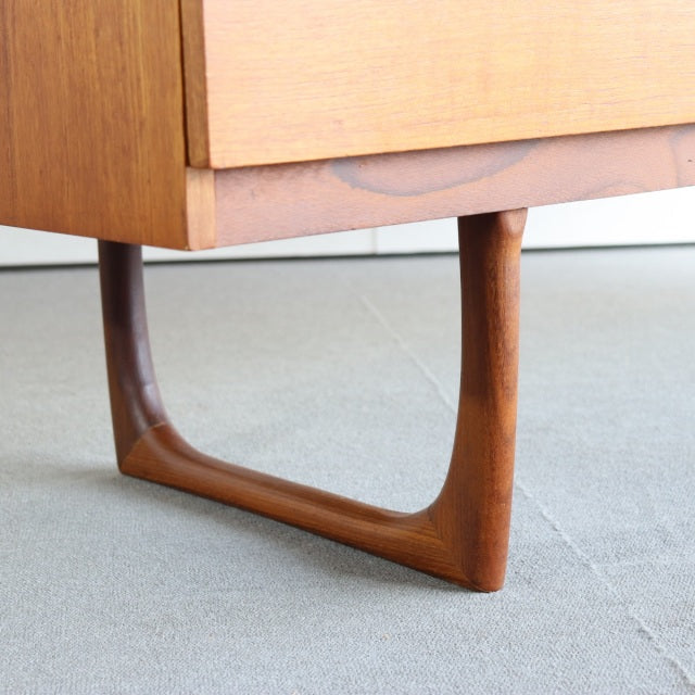 Vintage teak mid-century dresser leg with smooth grain and Danish-inspired British design.