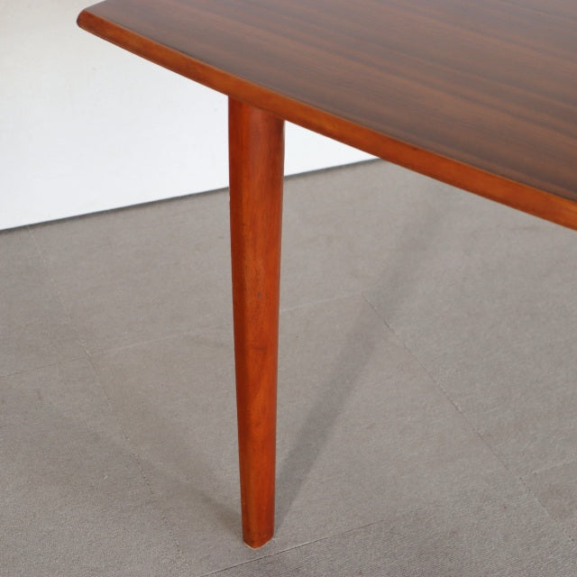 Vintage British mid-century teak dining table with rectangular top, smooth wood grain, and tapered legs from Denmark.