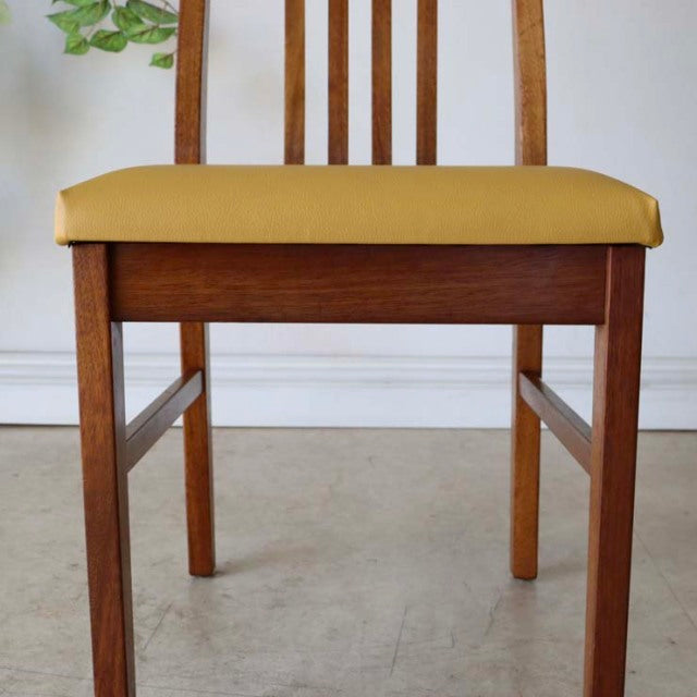 Mid-century vintage teak dining chair with yellow upholstered seat, British or Danish design, vertical slat back, clean wood .