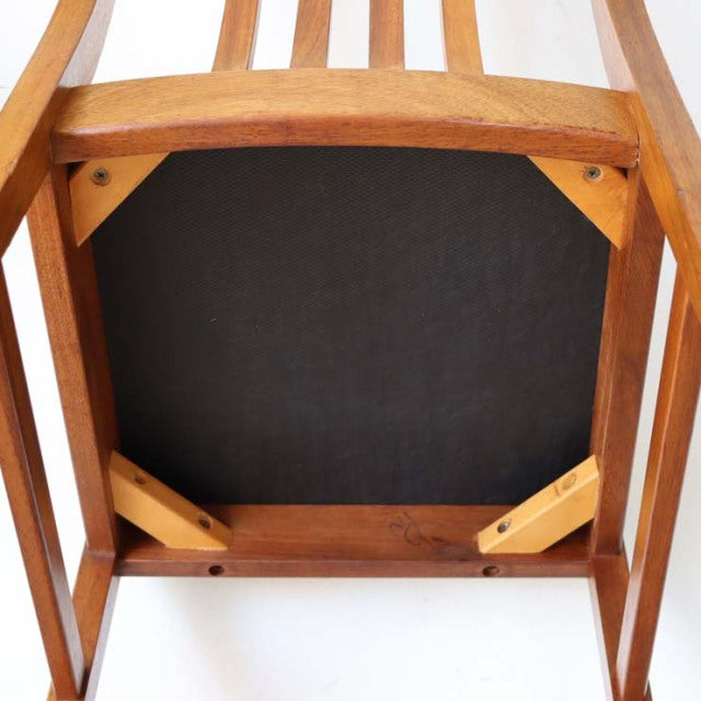 Mid-century vintage teak dining chair from Denmark with visible wood grain and sturdy frame, yellow seat cushion.