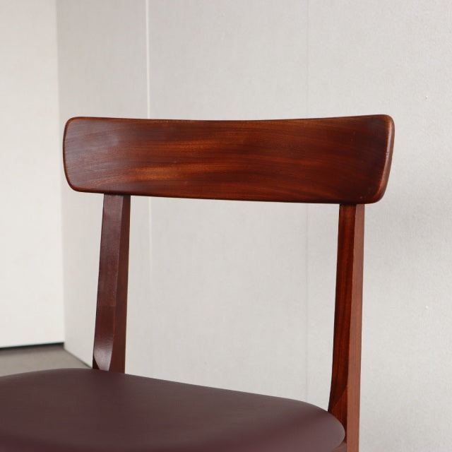 Vintage teak dining chair by Younger, British mid-century design with smooth wood grain and curved backrest.