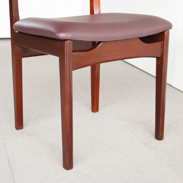 Mid-century vintage British teak dining chair by Younger with smooth wood grain and curved brown leather seat upholstery.