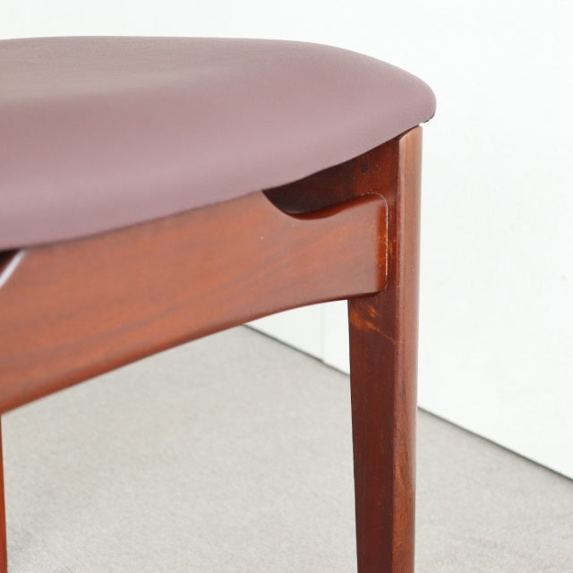 Mid-century vintage British teak dining chair leg with smooth wood grain and mauve upholstered seat from Younger Denmark.