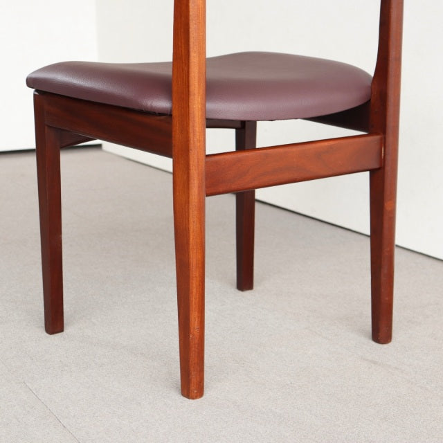 Vintage teak Younger dining chair from mid-century Britain with rich wood grain and padded maroon leather seat.