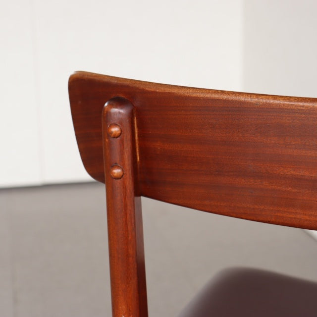 Vintage mid-century teak dining chair backrest with smooth wood grain and rounded vertical supports, British-Scandinavian.