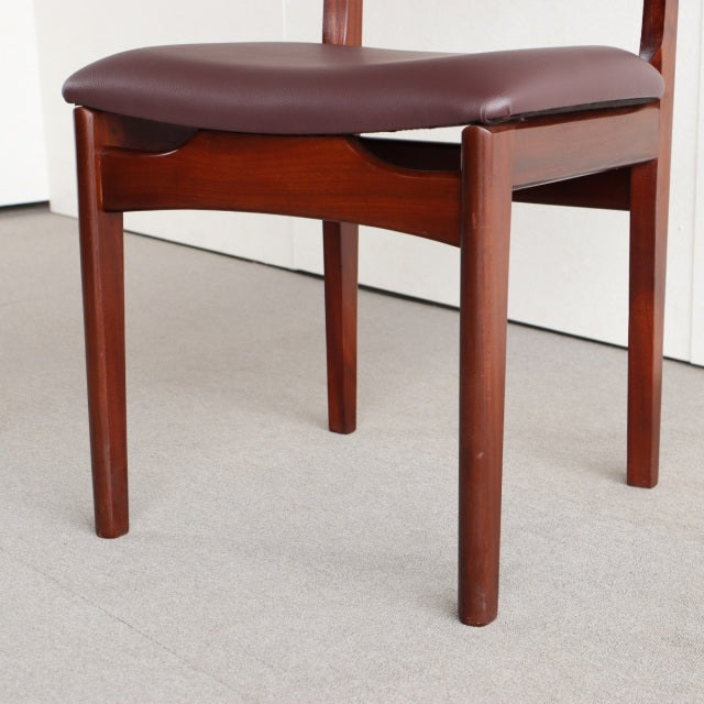 Mid-century British vintage teak dining chair with smooth wood grain, straight legs, and brown upholstered seat.