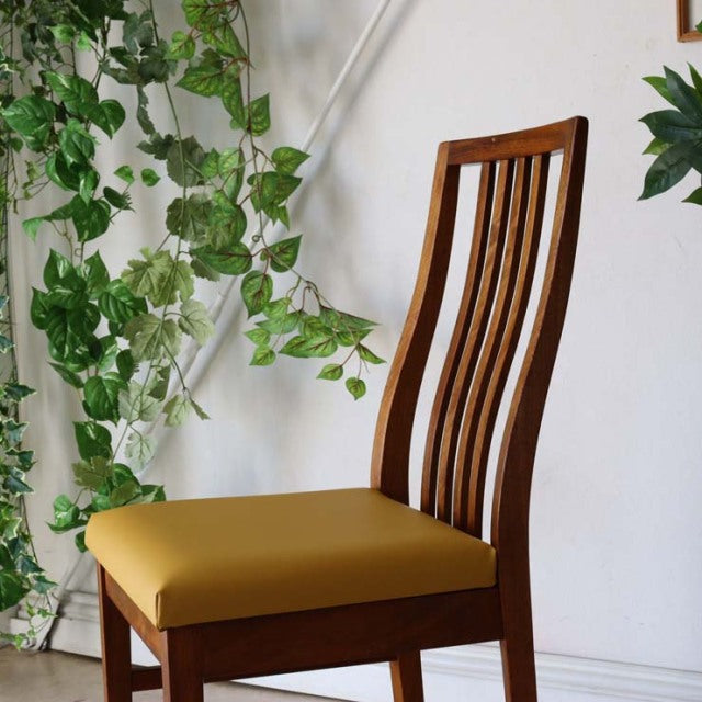 Mid-century British vintage teak dining chair with curved slatted back and yellow upholstered seat in excellent condition.