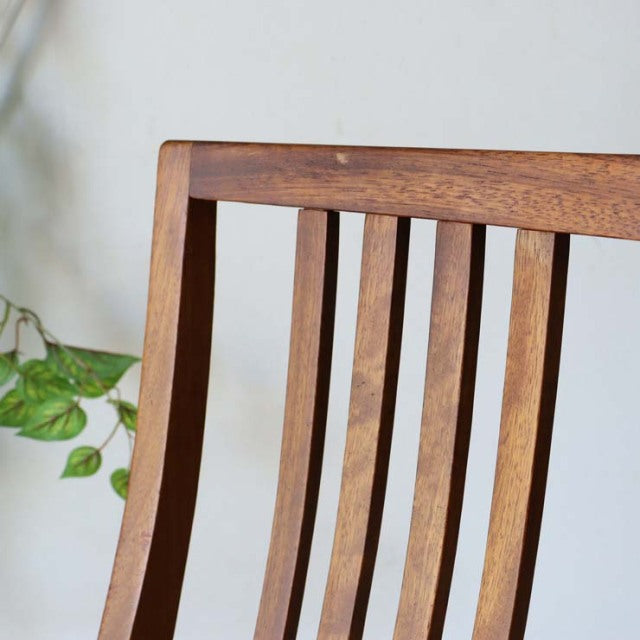 Mid-century British vintage teak dining chair with vertical slat backrest and rich wood grain.