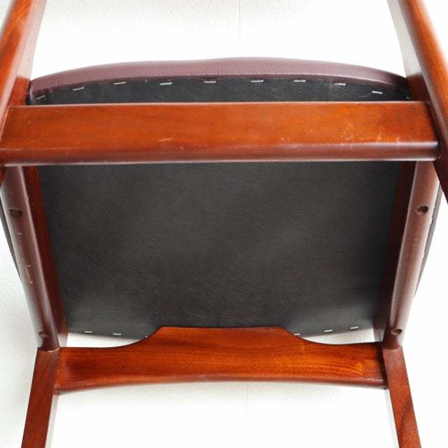 Mid-century British vintage teak dining chair base with warm wood grain and sturdy legs, showing underside construction.