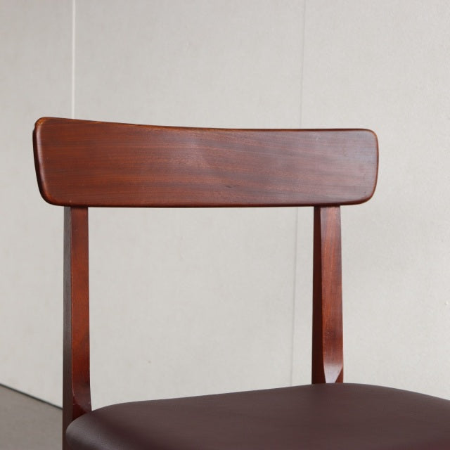 Vintage teak dining chair with British mid-century design, curved backrest, and tapered legs.
