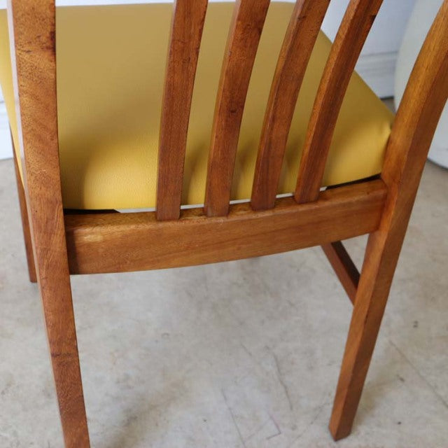 Mid-century British teak dining chair with curved slat back and mustard yellow upholstered seat in vintage condition.