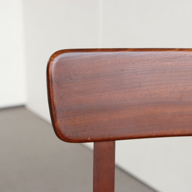 Mid-century vintage teak dining chair backrest with smooth wood grain and rounded edges, British-Denmark style.
