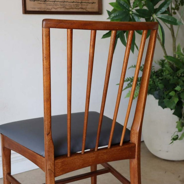 Vintage mid-century teak dining chair with slender vertical spindle back, British-Denmark design, black cushioned seat,.