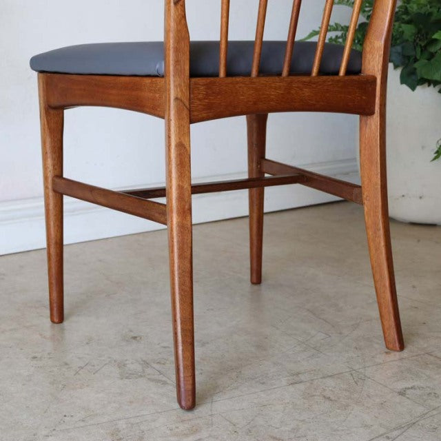 Vintage mid-century teak dining chair with British design, sharp-back spindles, and slender legs.