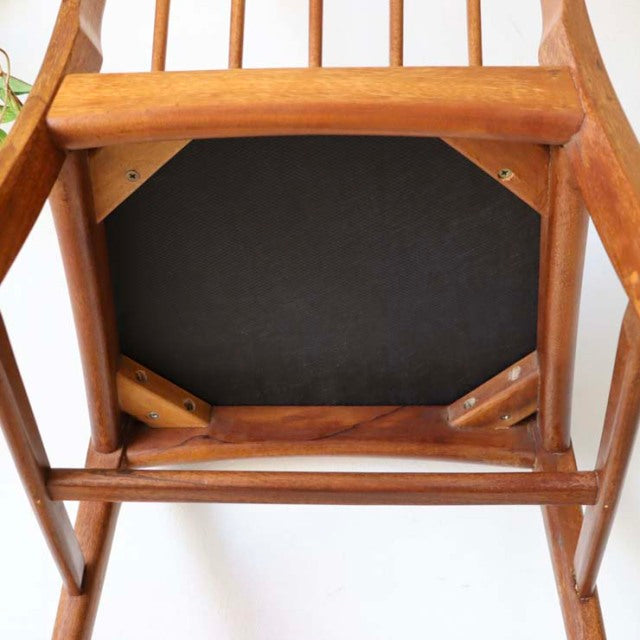 Vintage mid-century teak dining chair underside showing solid wood frame, sturdy legs, and authentic British-Denmark.