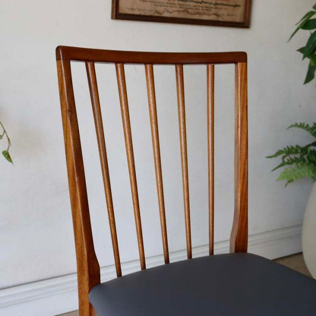 Vintage mid-century teak dining chair with slender vertical back slats, British-Denmark influence, clean sharp lines, smooth .