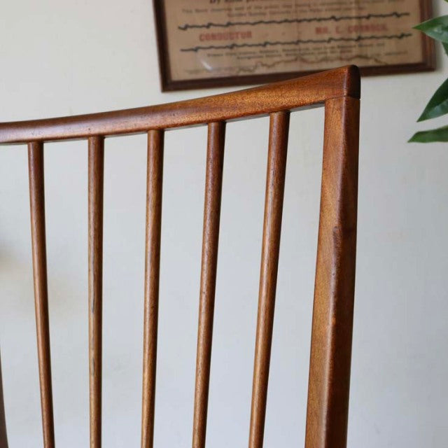 Vintage mid-century teak dining chair with slim vertical spindles and tapered legs, British-Denmark style.
