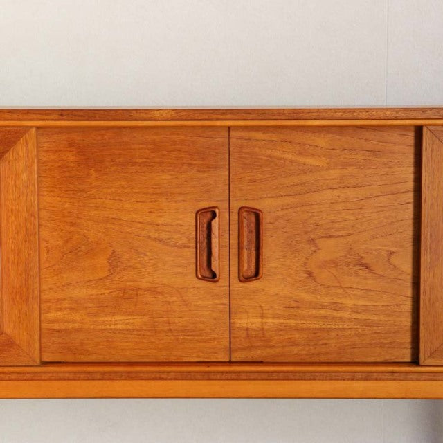 Mid-century British vintage teak sideboard with rich wood grain and recessed handles.