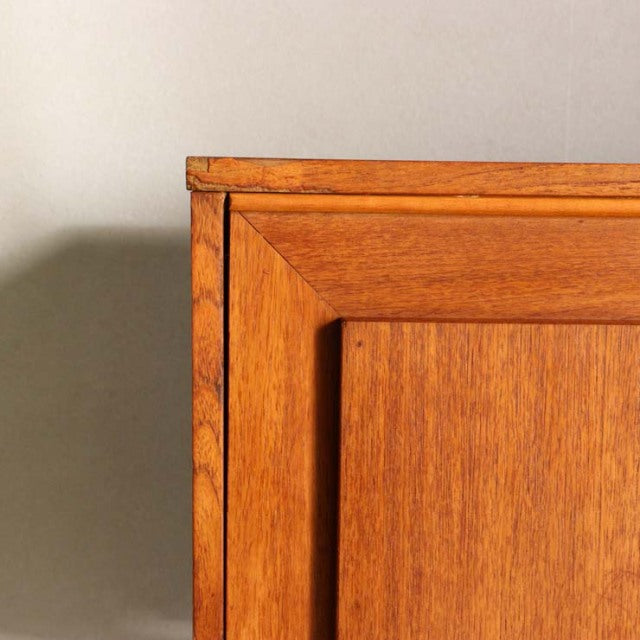 Close-up of vintage teak sideboard corner showcasing rich wood grain and mid-century British craftsmanship.