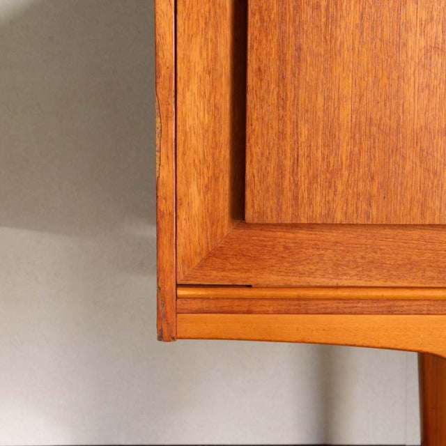 Close-up of vintage British mid-century teak sideboard corner showing rich wood grain and smooth craftsmanship from Denmark.