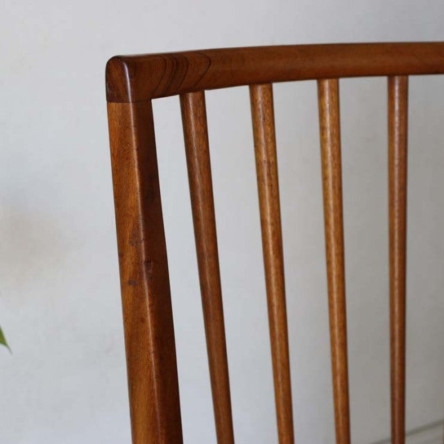 Vintage mid-century teak dining chair from Denmark with slender vertical slats and a sharp, angular backrest showcasing rich .