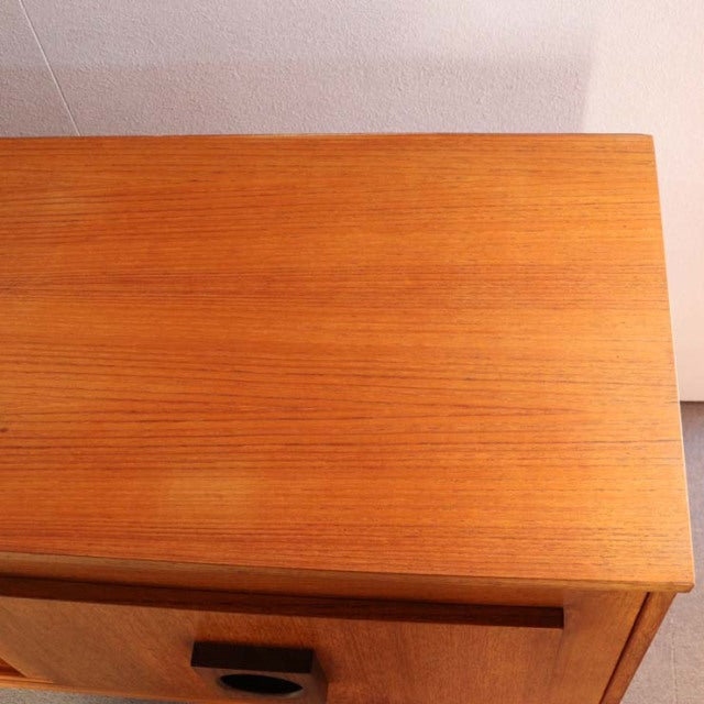 Vintage mid-century teak sideboard with smooth wood grain and clean lines, British-Denmark style.