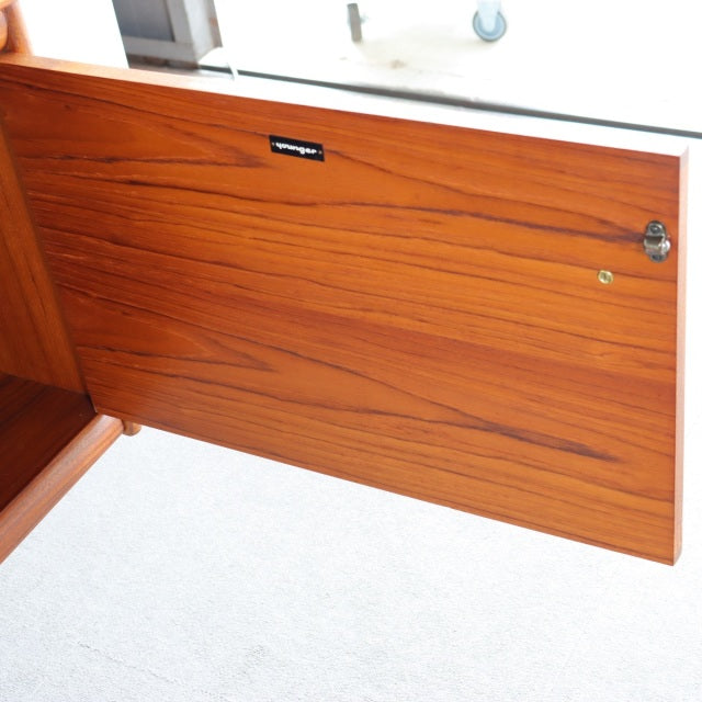 Mid-century British teak sideboard door panel with rich wood grain and YOUNGER brand plaque.