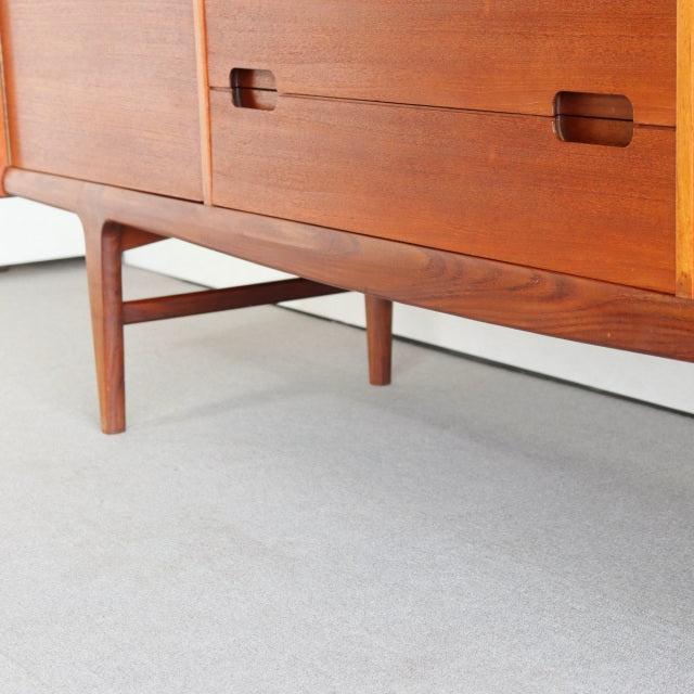Vintage teak sideboard by YOUNGER with smooth wood grain, British mid-century design, and slender Danish-style legs.
