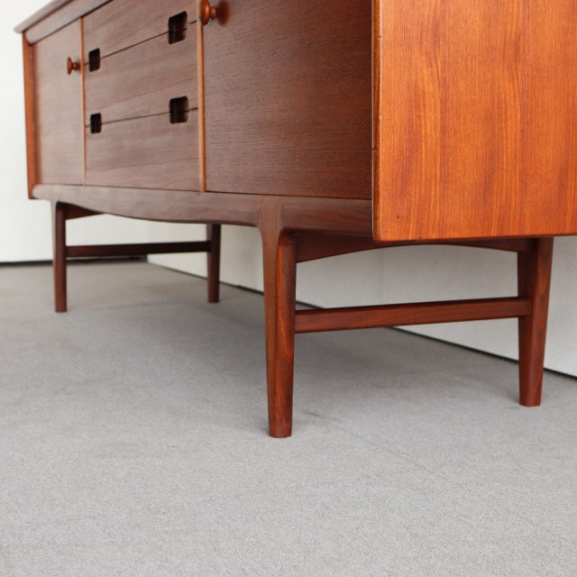 Mid-century British vintage teak sideboard by Younger with rich wood grain, clean lines, and tapered legs.