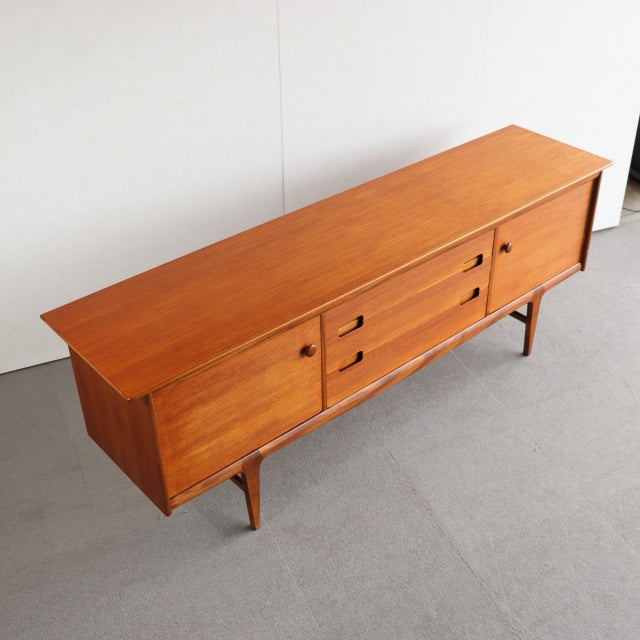 Vintage teak sideboard by YOUNGER with mid-century British-Denmark design, sleek wood grain and tapered legs.