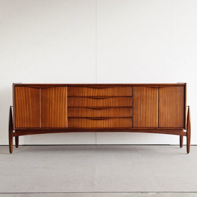 Mid-century British vintage teak sideboard by Elliotts of Newbury with slatted doors and central drawers on tapered legs.