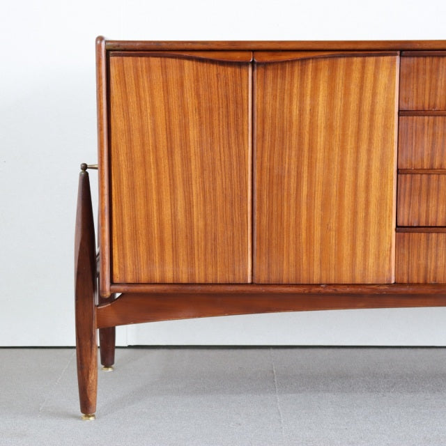 Mid-century British teak sideboard by Elliotts of Newbury with rich wood grain, tapered legs, and clean-lined design.