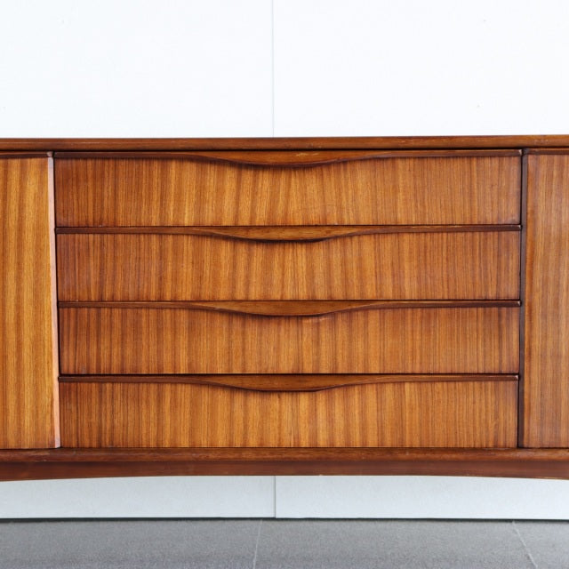 Vintage British mid-century teak sideboard by Elliotts of Newbury with rich wood grain and sleek recessed handles.